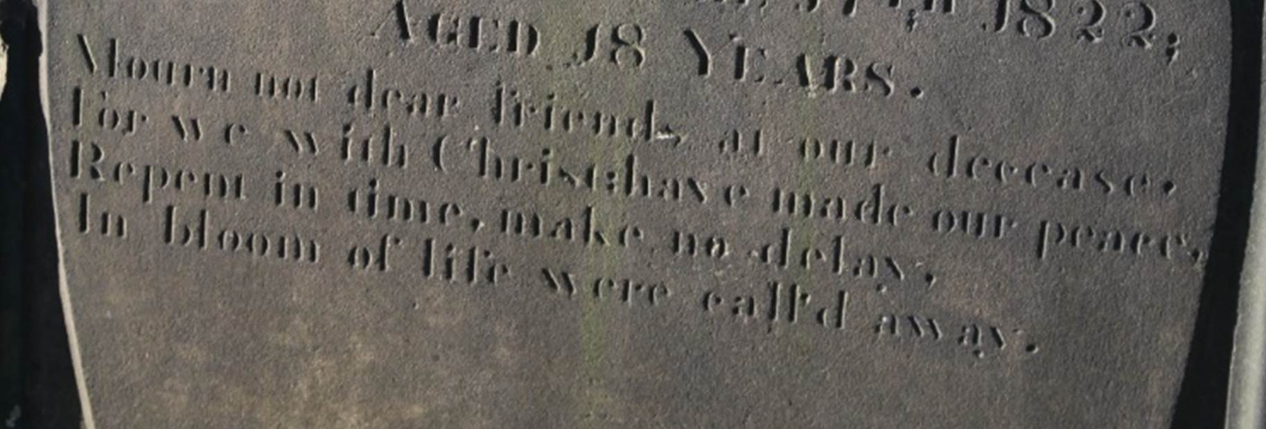 A tombstone in a cemetery

Description automatically generated